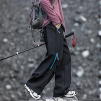 
                  
                    Water-repellent fleece hiking pants for cold days - black fleece-lined hiking pants with pink jacket
                  
                