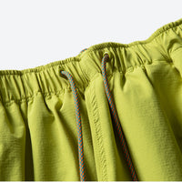 
                  
                    Unisex lightweight outdoor cargo pants - lime green, waistband drawstring close-up detail, for camping and travel
                  
                