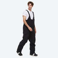 
                  
                    Unisex waterproof 2L snow jacket and bib pants - white bib pants, on-model front view, for cold-weather winter sports
                  
                