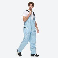 
                  
                    Unisex snowboard jacket and bibs set - ice blue bib pants, on-model front view, for resort and backcountry days
                  
                