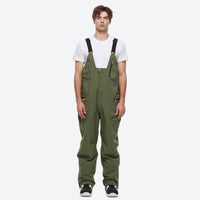 
                  
                    Unisex waterproof 2L snow jacket and bib pants - olive green bib pants, on-model front view, for powder and piste riding
                  
                