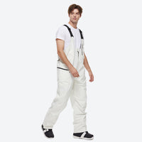 
                  
                    Unisex snowboard jacket and bibs set - black bib pants, on-model walking three-quarter view, for skiing and snowboarding
                  
                