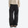 Water-repellent nylon hiking pants with relaxed fit - black wide-leg hiking pants with cream top, front standing view