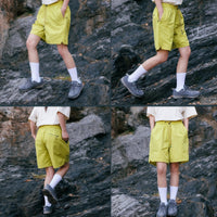 
                  
                    Water-repellent nylon shorts for outdoor - lime green quick-dry shorts with white tee, for travel and city walks
                  
                