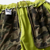 
                  
                    Unisex lightweight outdoor cargo pants - lime green, interior camo lining close-up detail, for hiking and trekking
                  
                