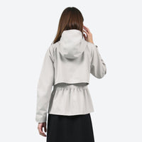 
                  
                    Women's hooded hardshell with slim waist fit - light gray off-white jacket front and lifestyle views, on-model back hood view
                  
                