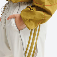 
                  
                    Breathable water-repellent trekking pants with vents - white pants with gold stripes, for camping and travel
                  
                