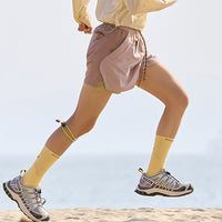 
                  
                    Unisex water-repellent shorts with breathable liner - pink water-repellent shorts with white top, for warm-weather training
                  
                