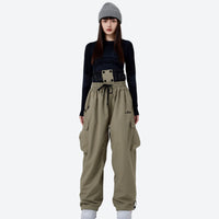 
                  
                    Unisex 2L snow jacket and cargo pants set - white pants colorway, on-model side view, for resort and backcountry skiing
                  
                