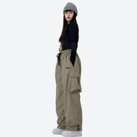 
                  
                    Waterproof 2L ski jacket pants combo - brown pants colorway, on-model side view, for resort and backcountry skiing
                  
                