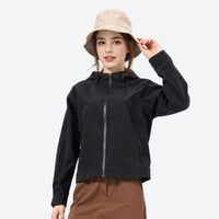 
                  
                    Curve women's 3L hardshell waist-cinching jacket - black jacket front and lifestyle views, for mountain trekking and climbing
                  
                