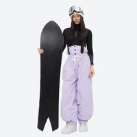 
                  
                    Women's waterproof 2L snow jacket and bib pants series - lavender bib pants with black top, for cold-weather winter sports
                  
                