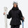 Women's belted snow jacket with suspender pants - black, front with upright skis and poles, for cold-weather winter sports