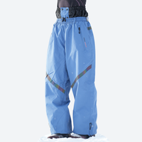 
                  
                    Waterproof snow jacket and pants set - blue, on-model front with upright snowboard, for resort and backcountry days
                  
                