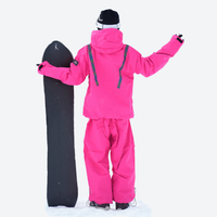 
                  
                    Waterproof snow jacket and pants set - red, on-model front with upright snowboard, for skiing and snowboarding
                  
                