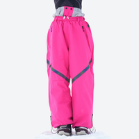
                  
                    Waterproof snow jacket and pants set - red, on-model front holding snowboard, for cold-weather winter sports
                  
                