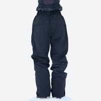 
                  
                    Colorblock snowboard jacket and pants set - black, on-model side view, for skiing and snowboarding
                  
                