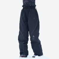 
                  
                    Breathable ski jacket and snow pants combo - black, on-model front with upright snowboard, for cold-weather winter sports
                  
                