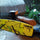 Surfboard rack for scooters and mopeds - rack mounted on scooter with surfboard lifestyle shots, on-model side view