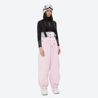 
                  
                    Women's 2-layer snowboard jacket and bibs - light pink bib pants with black top, for cold-weather winter sports
                  
                