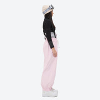
                  
                    Women's 2-layer snowboard jacket and bibs - light pink bib pants with black top, for powder days and winter commute
                  
                