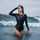 Serene UPF50+ women's one-piece rashguard - long sleeve black rashguard with shoulder cutout views, on-model side view